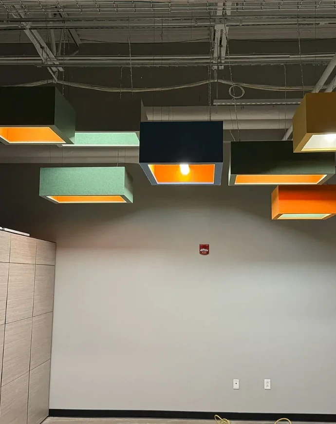 Colorful suspended box-shaped acoustic light fixtures